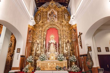 Seville, Spain - January 4, 2023: Main altar of the Virgen de la Esperanza de Triana inside the Capilla de los Marineros (Chapel of the Sailors) in the Triana neighborhood, Seville, Andalusia, Spain