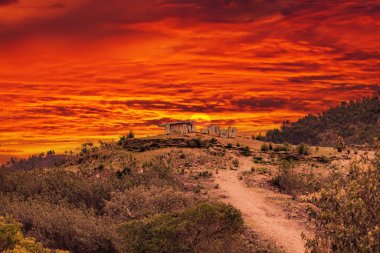 Dolmen number 1 of Megalithic formation of Dolmen de El Pozuelo at sunset. The archaeological site of El Pozuelo is located on rustic land in Zalamea la Real, in Huelva, Andalusia, Spain clipart