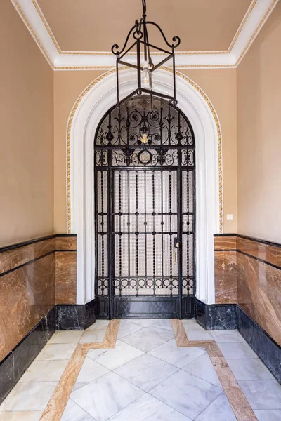 stock image Black wrought iron bar door with glass window from 1907