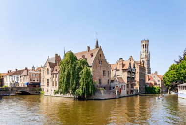 The Quay of the Rosary (Rozenhoedkaai) canal in Bruges with the classic medieval buildings and the Belfry Tower of Bruges in the background, Belgium clipart