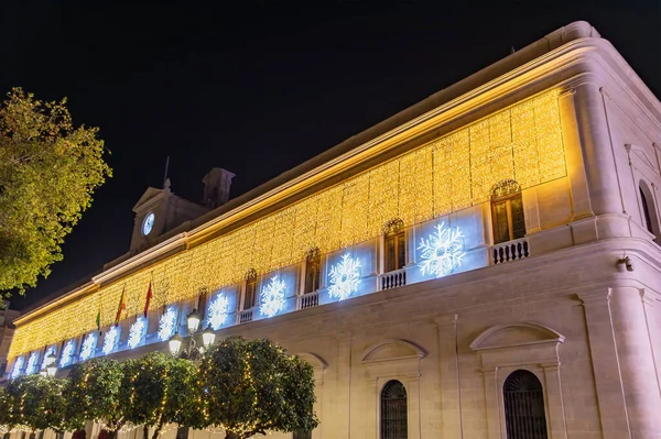 Christmas lights decoration in the facade of Seville City Hall, Andalusia, Spain. Selective focus with focus in the nearest lights