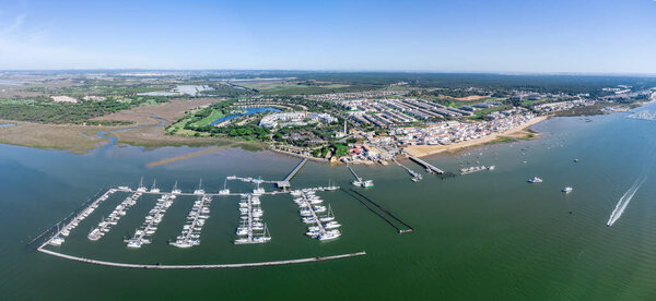 Aerial panoramic view of El Rompido beach village with Marina El Rompido Sports Port and the Piedras river
