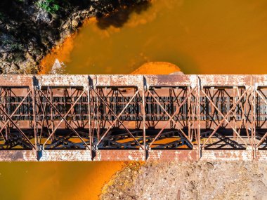 The Salomon Bridge crossing the red river, Rio Tinto, is a railway bridge in the province of Huelva and was originally part of the Riotinto railway for the transportation of copper mineral to Huelva clipart