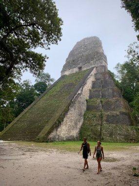 Flores, El Peten, Guatemala - 21 Şubat 2020: İki Turist Piramidi Geçiyor