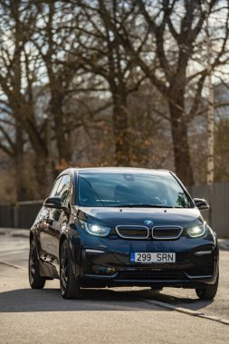 Tallinn, Estonia - March 23 2025: Stylish dark blue BMW i3s 2021 electric car parked in front of an old building. Eco-friendly, automotive and city lifestyle concept.