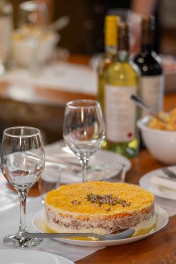Mimosa 'nın balık, yumurta ve sebzelerden yaptığı geleneksel Rus salatasıyla şenlik masası. Tatil yemekleri, Slav mutfağı, kutlama yemeği konsepti..