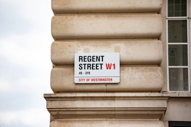 Londra, Westminster 'daki Regent Sokağı tabelasının yakın çekimi. Tabela bir taş binanın ön cephesine asılmış..