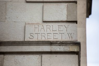 Londra 'daki Harley Caddesi yazıtlarıyla birlikte taş duvarın yakın çekimi. Tıbbi geçmişi ve mimarisi ile ünlüdür..