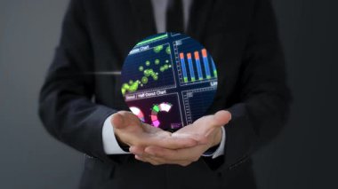 İş adamı holografik ekran ve hisse senedi veri grafiği tutuyor