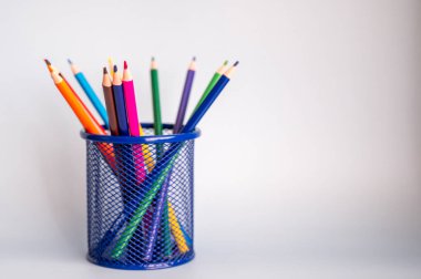 Beyaz arka planda duran renkli kalemler. Boşluğu kopyala