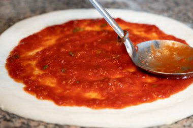 pizza base with tomato