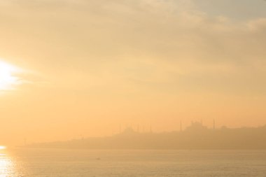 Arka planda cami, İstanbul, Türkiye, Smoky ve Foggy Air ile marmarmara denizi üzerinde güzel bir gün batımı