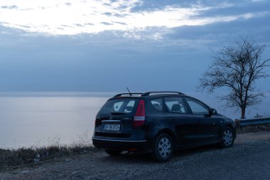 Türkiye 'nin Sinop kentinde Balck Denizi yakınlarında bir station wagon siyah araba ve bir ağaç