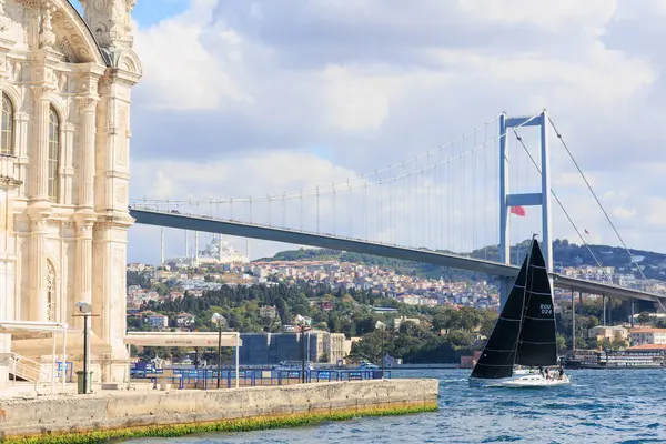 PORTHOS team's  sailboat front passing through under the Bosphorus bridge in 24th Bosphorus Cup on 20 September 2025