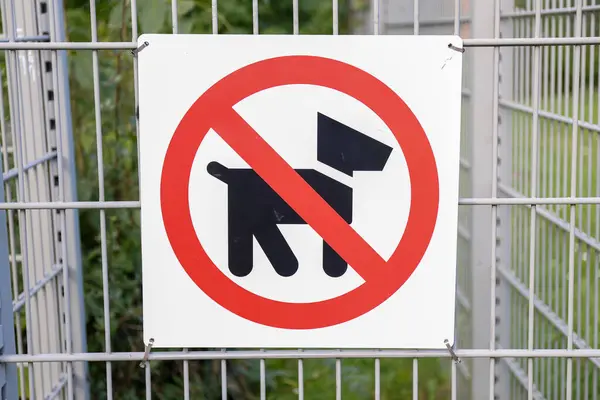 This sign clearly indicates a nodog policy within a fenced area to promote safety, cleanliness, and order throughout