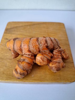 Servis panosundaki taze zerdeçal. Hareketli sarı rengiyle biliniyor. Aktif bileşik curkiminden geliyor. Zerdeçal, özellikle Güneydoğu Asya mutfağında lezzet ve renk artışı olarak yaygın olarak kullanılır.