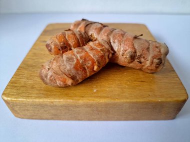 Servis panosundaki taze zerdeçal. Hareketli sarı rengiyle biliniyor. Aktif bileşik curkiminden geliyor. Zerdeçal, özellikle Güneydoğu Asya mutfağında lezzet ve renk artışı olarak yaygın olarak kullanılır.