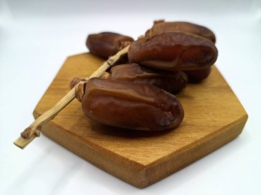 Servis panosundaki tarihler. Meyveleri salkımlı, salkımlı, salkımlı hurma ağaçları arasındadırlar. Genellikle doğal tatlılıklarıyla bilinirler ve genellikle atıştırmalık olarak ya da çeşitli tariflerde kullanılırlar.