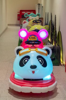 Bali, Endonezya - 17 Aralık 2024: Bali 'deki Icon Bali Alışveriş Merkezi. Sıra sıra panda temalı oyuncaklar koridorda dizilmiş. Panda arabası, parlak ışıkları ve neşeli tasarımı ile dikkatlerin odak noktasıdır..