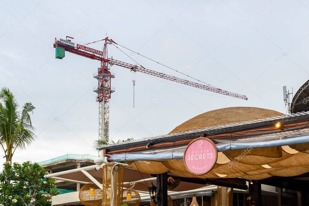 Bali, Indonesia - Dec 17, 2024: Restaurant with a sign that says L OSTERIA. There are several tables and chairs outside