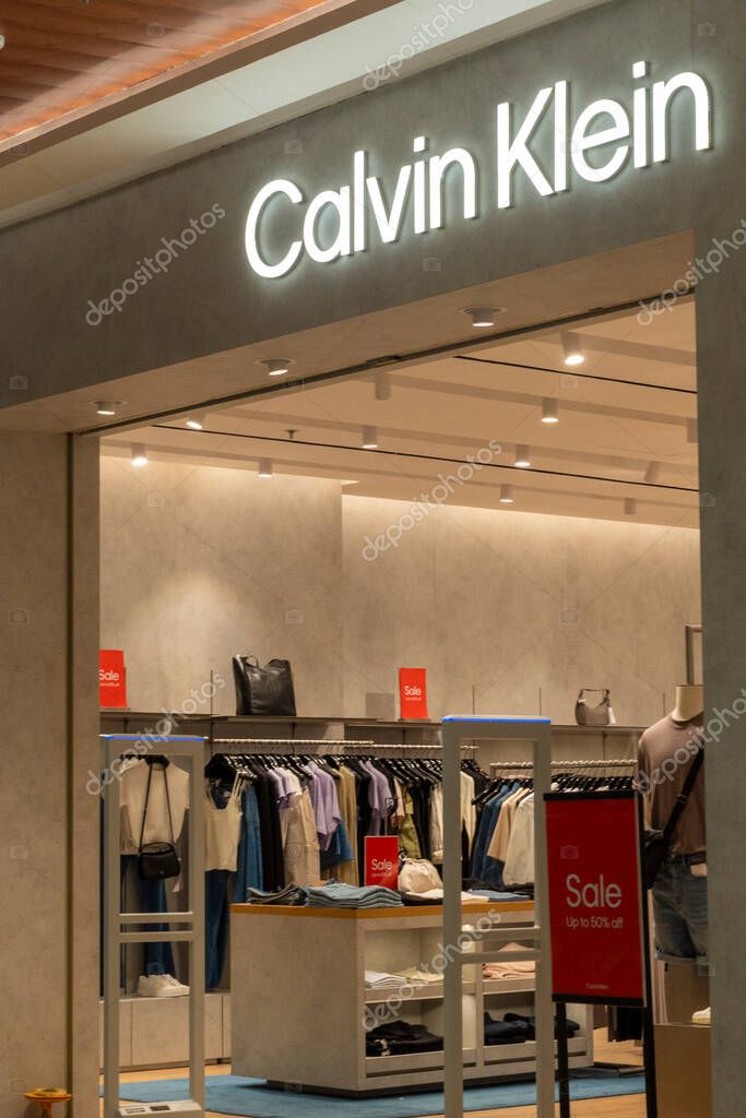 Bali, Indonesia - Dec 17, 2024: Icon Bali Mall in Bali. Woman walks into a store with a sign that says 