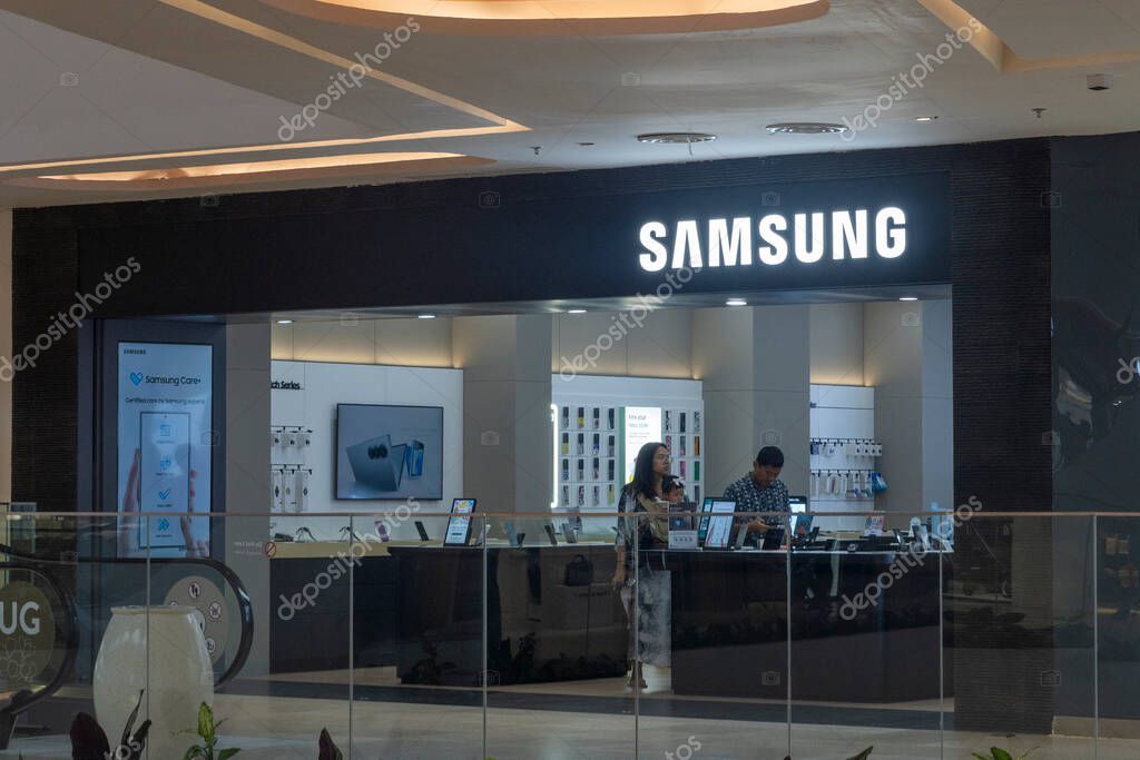 Bali, Indonesia - Dec 17, 2024: Icon Bali Mall in Bali. Samsung store with a man standing behind the counter. The store is open and has a clock on the wall