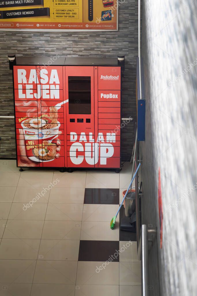 Jakarta, Indonesia - February 1, 2025: Red vending machine with a sign that says 