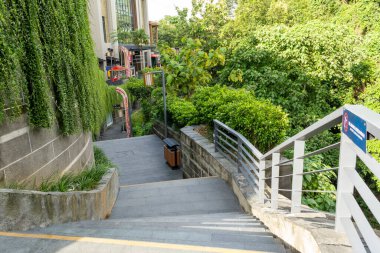 Bali, Endonezya - 23 Aralık 2024: Merdivenler parmaklıklı bir binaya çıkıyor. Korkuluklar metalden yapılmıştır ve beyazdır.