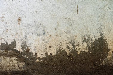 Bir sürü çatlağı ve boyası olan bir duvar. Duvar gri ve kabataslak bir dokusu var. Üç boyutlu doku ve malzeme için mükemmel.