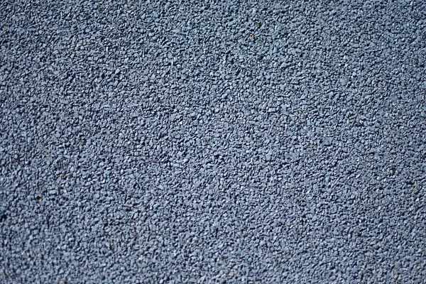 Mavi spor lastik kaplama kaplama yakın. Oyun alanı kaldırım arkaplan dokusu.