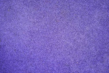 Mor spor lastik kaplama yakın çekim. Oyun alanı kaldırım arkaplan dokusu.