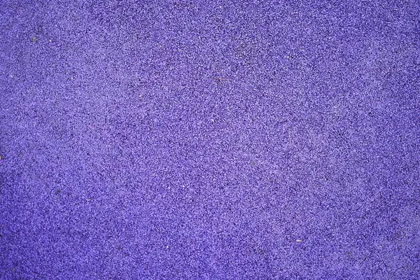 Mor spor lastik kaplama yakın çekim. Oyun alanı kaldırım arkaplan dokusu.