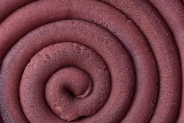 Hamur modelleme kil sarmal içine yuvarlandı üst ayrıntılı görünüm dokusu arka plan pembe