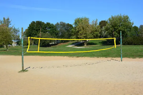 Açık havada boş plaj voleybolu sahası, güneşli yaz günlerinde direkler ve parktaki ağlar..