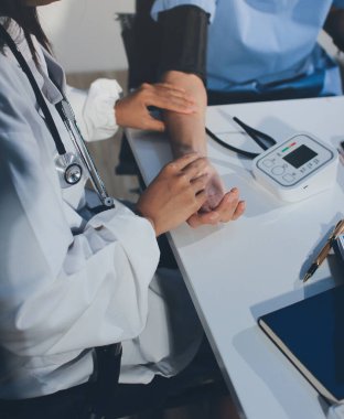 Hastanedeki hastanın kan basıncını ölçen doktor. Sağlık Hizmetleri Konsepti