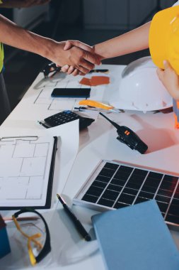 Endüstriyel mühendislerden oluşan bir ekip, fabrikadaki masada bulunan makine planlarını analiz ediyor. Fabrikada ya da üretim tesisinde çalışıyorum..