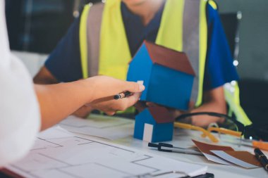 Endüstriyel mühendislerden oluşan bir ekip, fabrikadaki masada bulunan makine planlarını analiz ediyor. Fabrikada ya da üretim tesisinde çalışıyorum..