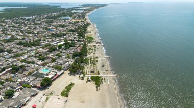 Atlantik Okyanusu 'nu ve Kolombiya' nın Cienaga, Magdalena kentindeki tropikal bir plajı gösteren ticari bir fotoğraf. Kıyı şeridinden yakalanan bu görüntü, Kolombiya 'nın Karayip kıyılarının güzelliğini vurguluyor.