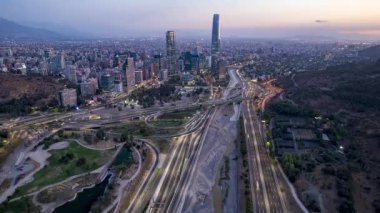 Santiago, Şili 21 Şubat 2024. Gün batımında Mapocho Nehri 'nden Costanera Merkezi ve Dağları' na doğru insansız hava aracı uçuşu..