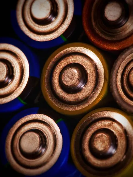 Metalik deseni ve renkli kaplamaları olan çeşitli bataryaların detaylı bir yakın çekimi.