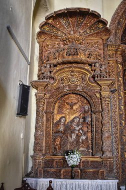 Daman, Gujarat 'taki 300 yıllık tarihi bir miras kilisesinde, dini figürlerin ve çiçeklerin yer aldığı, karmaşık oymalarla süslü, ahşap bir sunak..