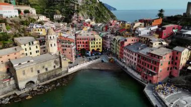 İtalya 'nın Cinque Terre bölgesinde bulunan renkli tarihi bir balıkçı kasabası olan Vernazza' nın çarpıcı hava aracı görüntüleri. Video, canlı evleri, dramatik kıyı şeridini, uçurumları ve Ligurian Denizi 'ni gün ışığında yakalıyor. Seyahat için ideal