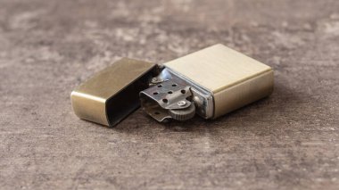 old vintage lighter on a wooden background. shallow depth of field clipart