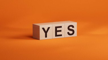 Evet kelimesi tahta bloklara siyah harflerle yazılmış. Mesaj evet anlamına geliyor. İş, motivasyon ve eğitim kavramı turuncu arka planda 3D.