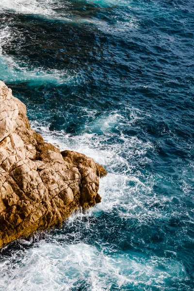 Water and rocks, top view of the Adriatic Sea in Dubrovnik, Croatia