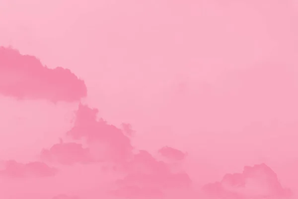 Pink clouds on light pink sky background, copy space