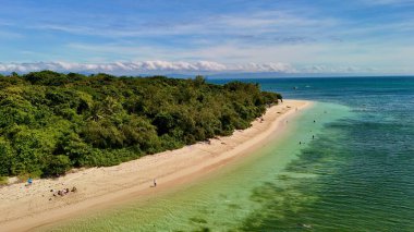Green Island 'ın hava görüntüleri. Queensland, Avustralya açıklarındaki Büyük Set Resifi' ndeki bir mercan mağarası. Sahne turkuaz suları, uçan resifler, beyaz kumsallar, uzun bir iskele ve iskeleyi ve yoğun tropikal yağmur ormanlarını yakalıyor. Popüler.