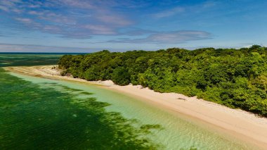 Green Island 'ın hava görüntüleri. Queensland, Avustralya açıklarındaki Büyük Set Resifi' ndeki bir mercan mağarası. Sahne turkuaz suları, uçan resifler, beyaz kumsallar, uzun bir iskele ve iskeleyi ve yoğun tropikal yağmur ormanlarını yakalıyor. Popüler.