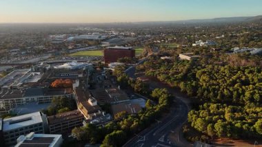 Flinders Üniversitesi, Central Park, Bedford Park, South Adelaide, Güney Avustralya: Bu 4K hava aracı, günbatımında üniversite kampüsünü, modern akademik binaları, geniş karıncaları, çalılıkları ve