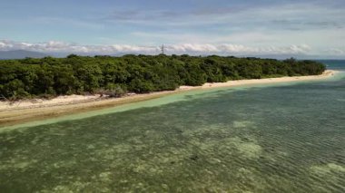 Green Island 'ın hava görüntüleri. Queensland, Avustralya açıklarındaki Büyük Set Resifi' ndeki bir mercan mağarası. Sahne turkuaz suları, uçan resifler, beyaz kumsallar, uzun bir iskele ve iskeleyi ve yoğun tropikal yağmur ormanlarını yakalıyor. Popüler.
